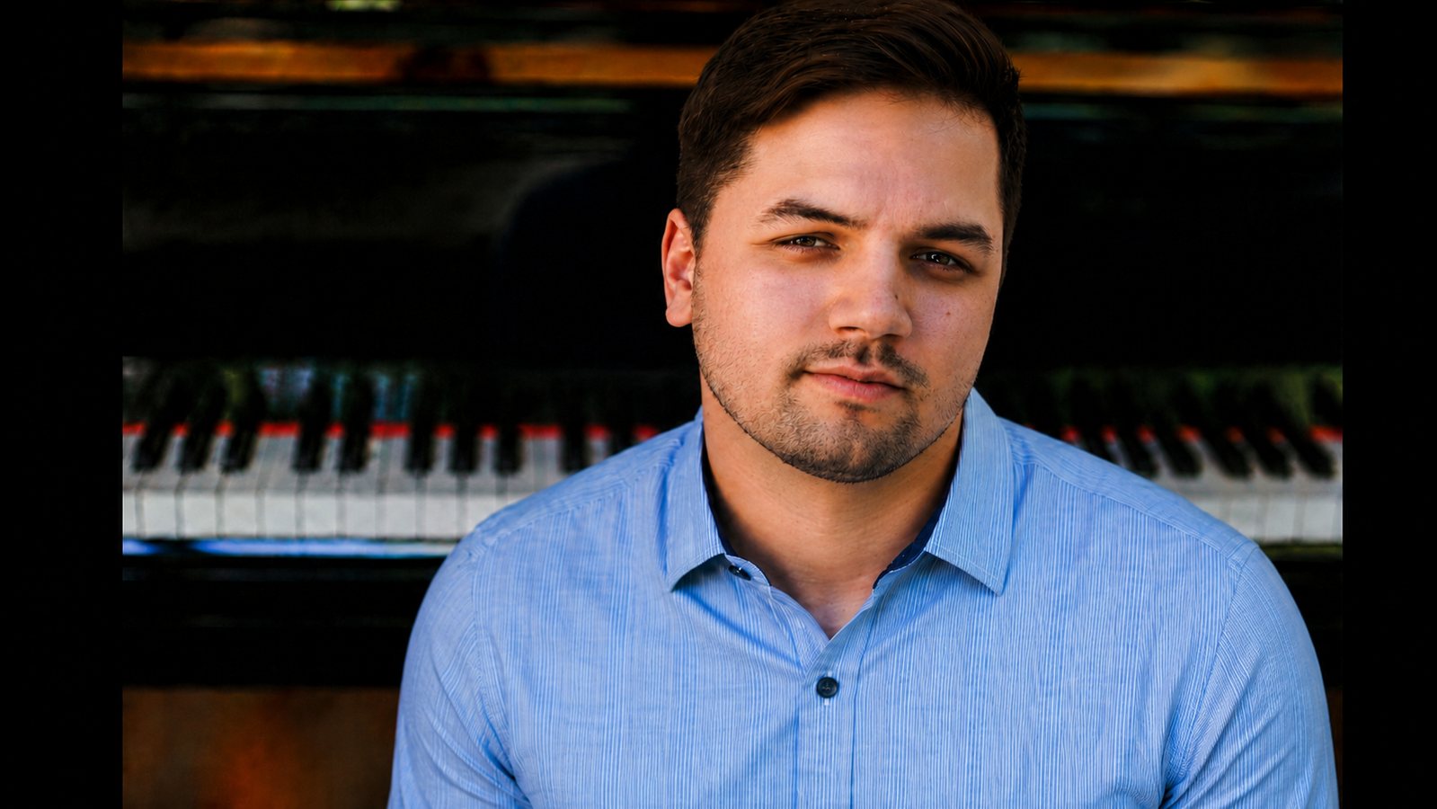 Thaddeus Arndt in front of a piano