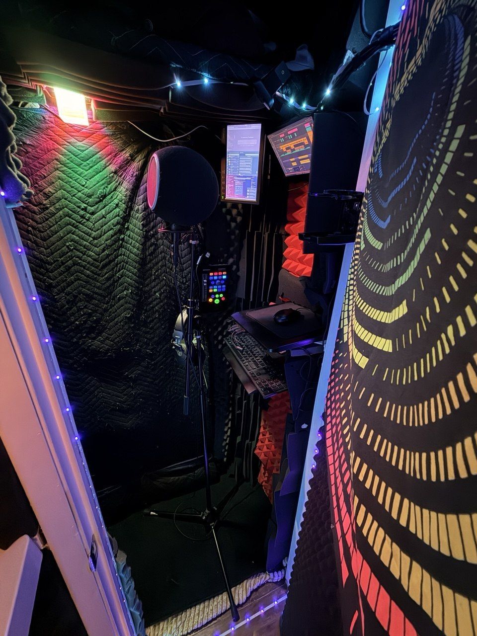 Vocal booth — acoustic blankets, foam, LED string lights, mic stand, psychedelic tapestry